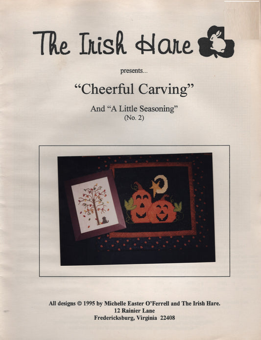 A printed pattern cover titled "Cheerful Carvings' by The Irish Hare halloween pumpkin cross stitch pattern