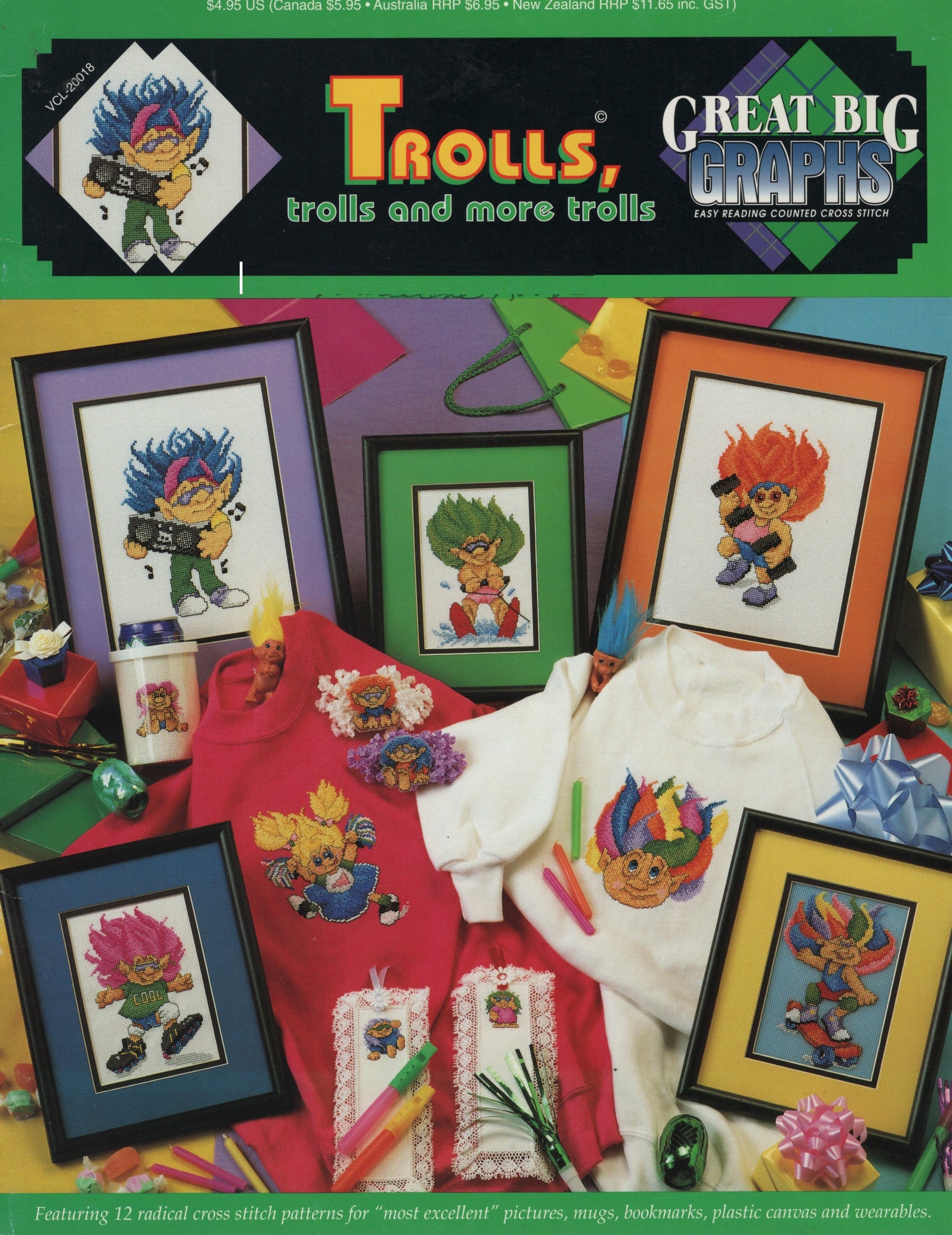 Front cover of a cross stitch pattern book titled "Trolls, trolls and more trolls" by Great Big Graphs. The cover shows multiple framed Trolls character designs and colorful craft items arranged together on a bright multicolor background. VCL-20018