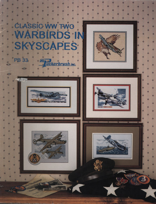 A vintage cross stitch book titled 'Classic WW Two Warbirds in Skyscapes' with five airplane illustrations  by Puckerbrush PB33