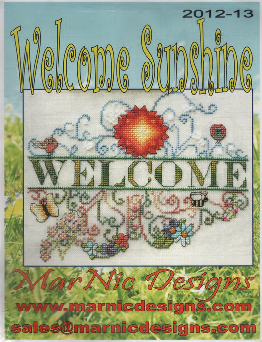 A cross-stitch design titled 'Welcome Sunshine' with 'WELCOME' stitched across the center and decorative floral and butterfly motifs. Large stylized text at the top reads 'Welcome Sunshine,' and the bottom shows 'Marnic Designs'  2012-13
