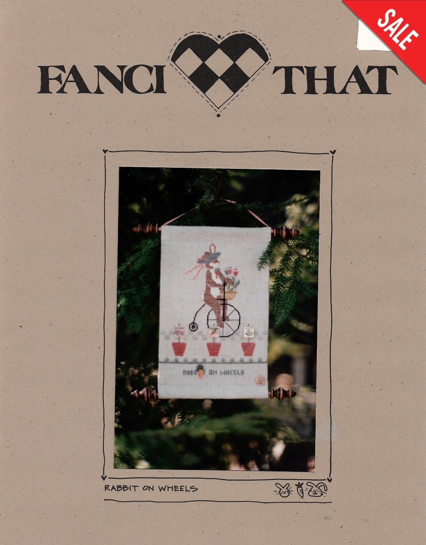 Fanci That Rabbit on Wheels primitive cross stitch pattern