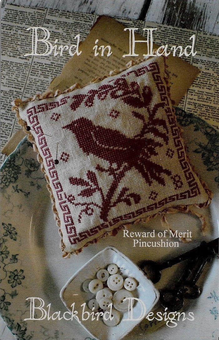 Blackbird Bird in Hand Reward of Merit pincushion cross stitch pattern